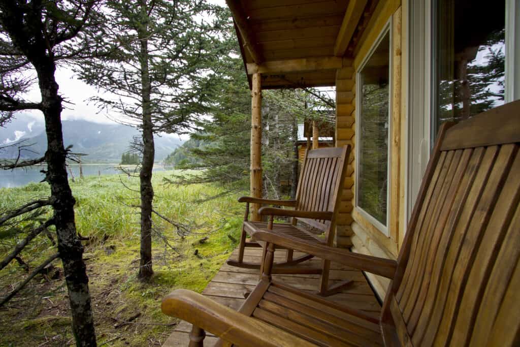 The deck from one of the cabins has two rocking chairs and views of Pedersen Lagoon