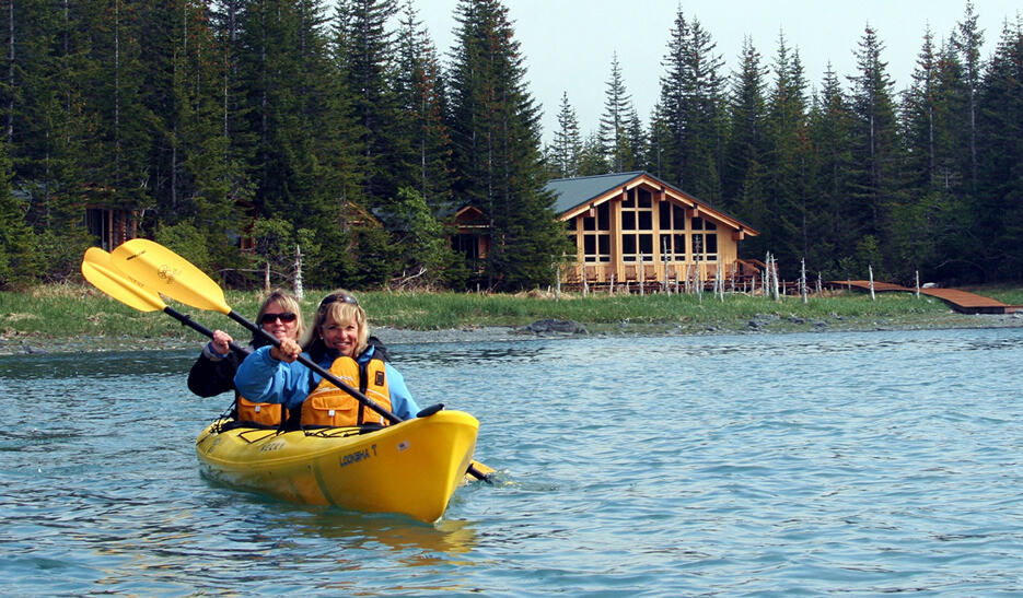 Two kayakers in front of Kenai Fjords Glacier Lodge