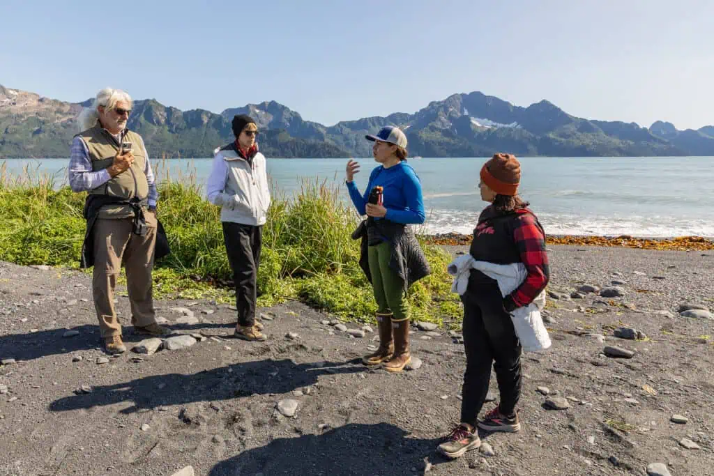 Discussing the area while beachcombing on Aialik Bay