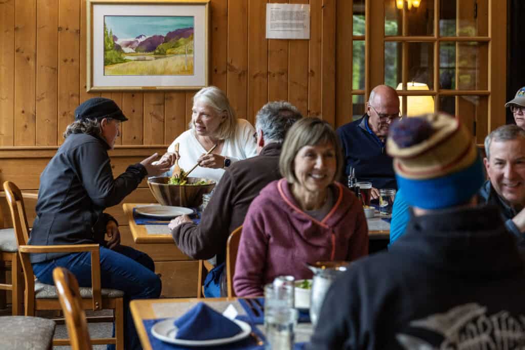 Guests at Kenai Fjords Glacier Lodge enjoy visiting and sharing stories during dinner