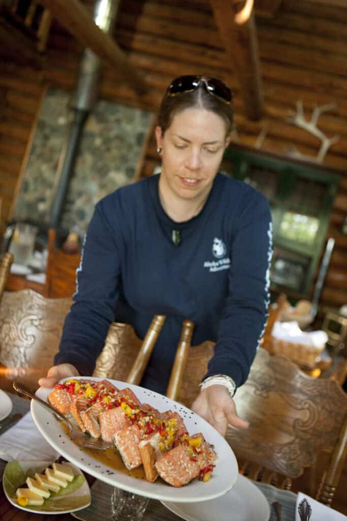 Serving salmon as part of the wilderness fine dining at Kenai Backcountry Lodge