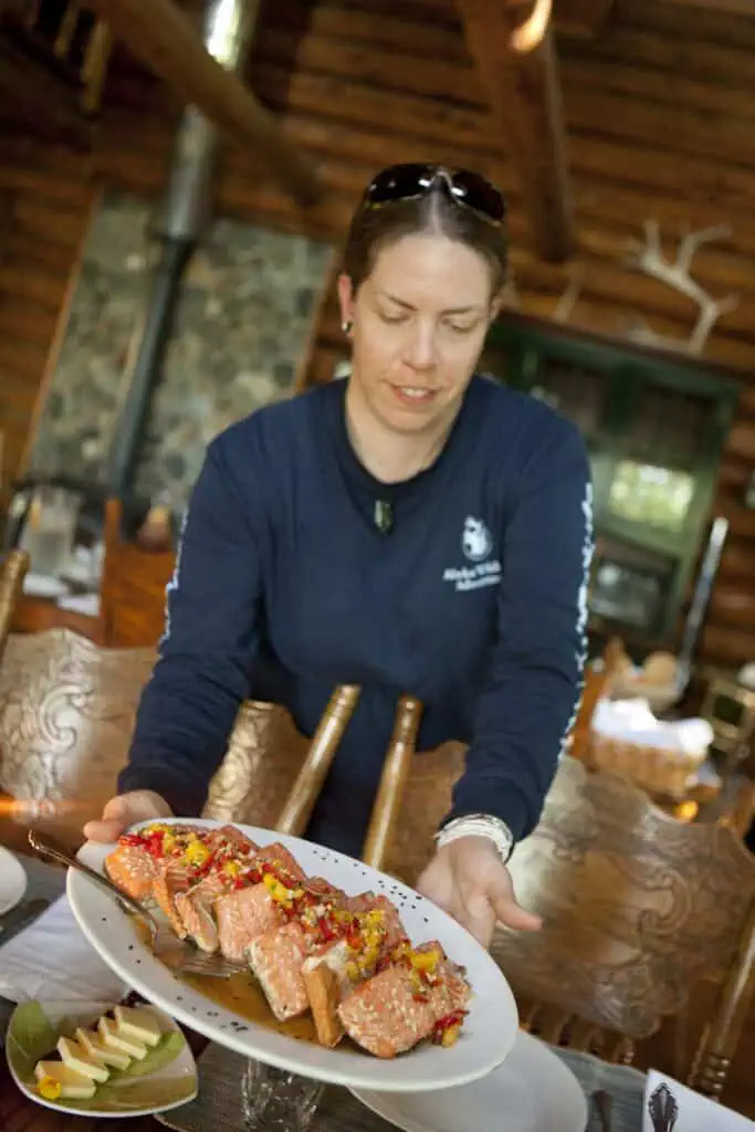 Serving salmon as part of the wilderness fine dining at Kenai Backcountry Lodge