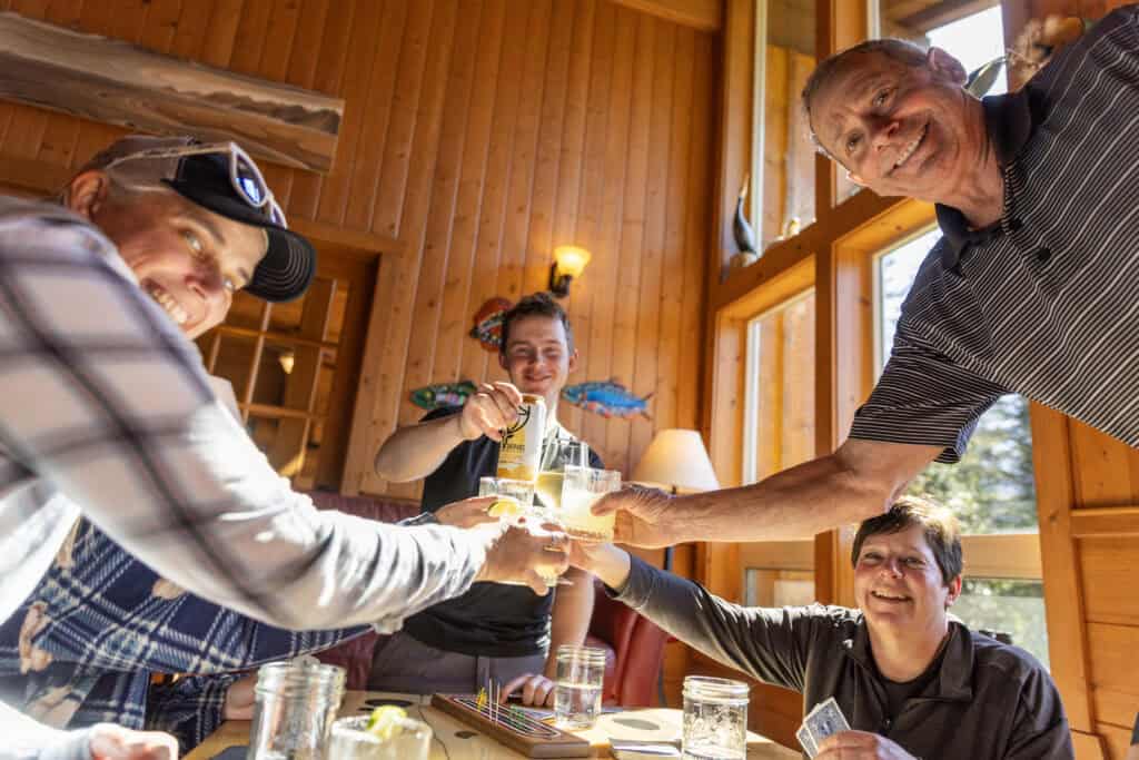 Guests enjoying pre-dinner drinks in the Kenai Fjords Glacier Lodge lounge