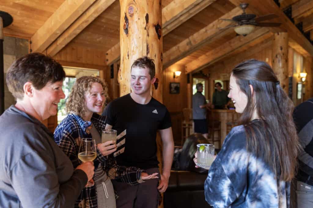 Guests visit in the Kenai Fjords Glacier Lodge lounge before dinner